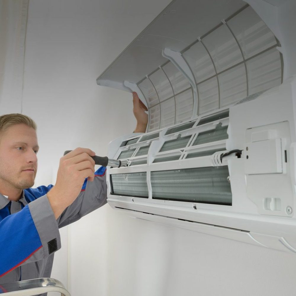 repairer-repairing-air-conditioner